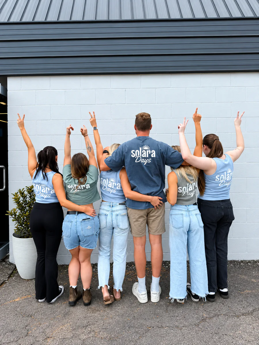 A group wearing SOLARA Days shirts outside the cafe